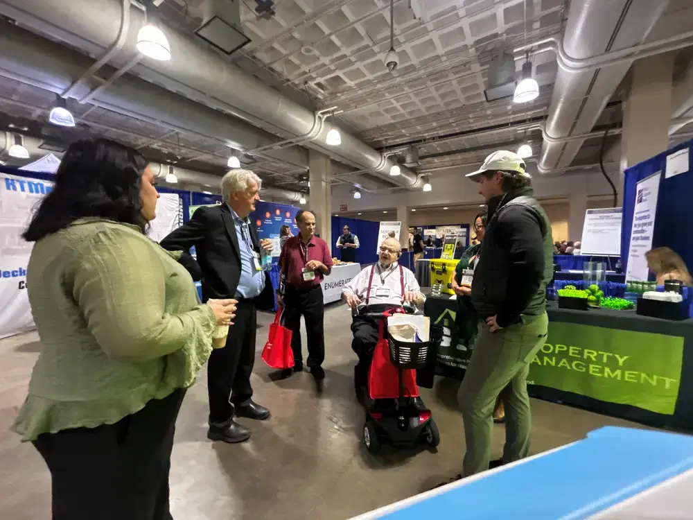 GIM Property Management team talking with guests at a community gathering