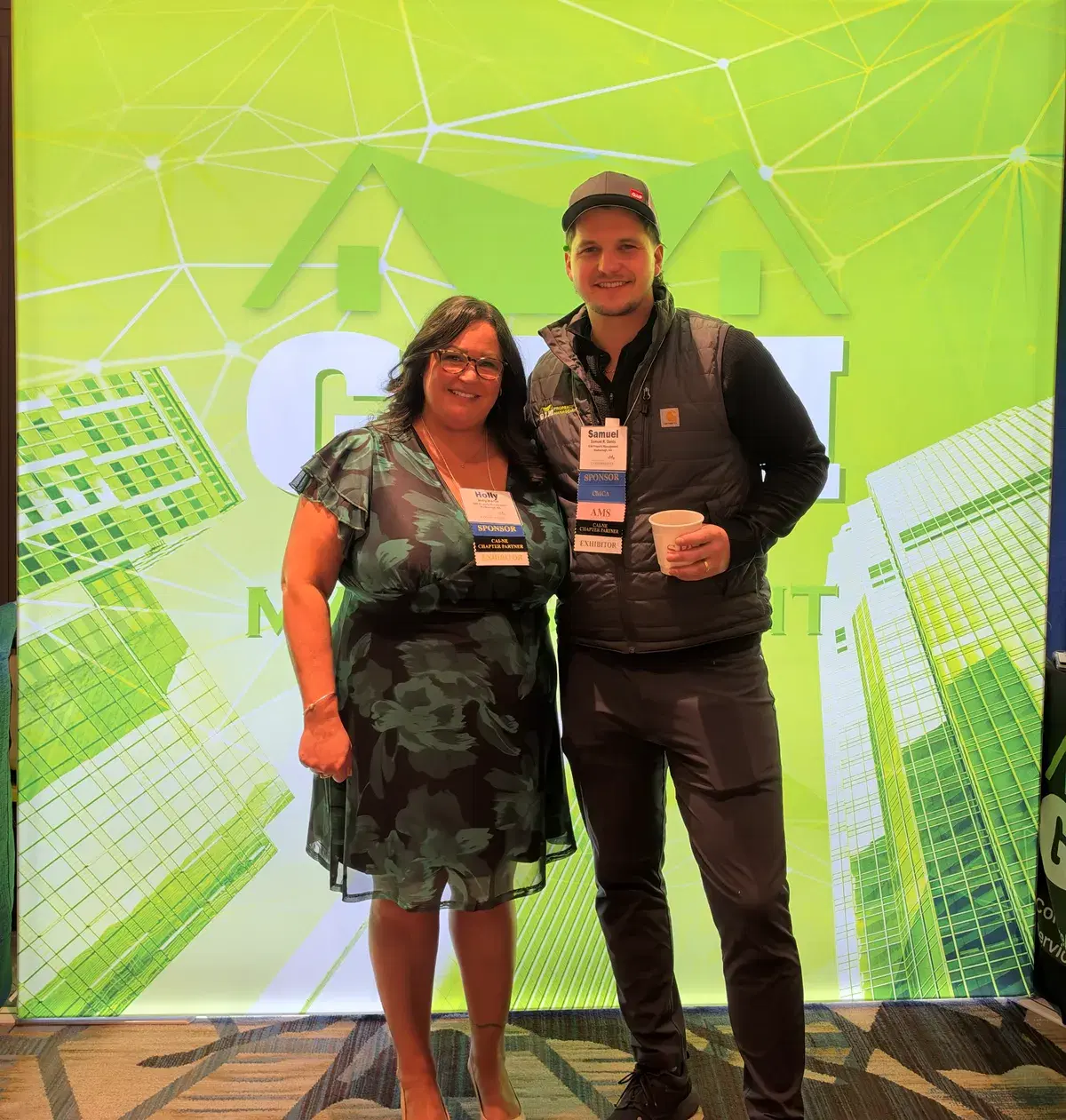 GIM Property Management team members at the company booth during a CAI New England event